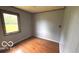 Bedroom featuring hardwood floors, light gray walls, and a window at 2414 S Rybolt Ave, Indianapolis, IN 46241