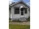 Close up of the home's front entrance with small porch awning and chain link fence at 2414 S Rybolt Ave, Indianapolis, IN 46241