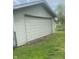 Side view of garage door with siding and green lawn at 2414 S Rybolt Ave, Indianapolis, IN 46241