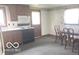 Well-lit kitchen featuring wood cabinets, appliances, and dining area with seating at 2414 S Rybolt Ave, Indianapolis, IN 46241