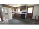 Traditional kitchen with wood cabinets, appliances, and dining area at 2414 S Rybolt Ave, Indianapolis, IN 46241