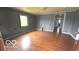 Hardwood floors and neutral wall paint are showcased in this spacious living room at 2414 S Rybolt Ave, Indianapolis, IN 46241