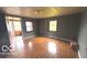 Spacious living room showcasing hardwood floors, neutral wall paint, and a view of the porch at 2414 S Rybolt Ave, Indianapolis, IN 46241