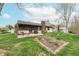 Spacious backyard with patio, screened-in porch and flower bed perfect for outdoor living at 3003 Foxpointe Dr, Columbus, IN 47203