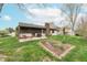 Spacious backyard with patio, screened-in porch and flower bed perfect for outdoor living at 3003 Foxpointe Dr, Columbus, IN 47203
