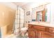 Bathroom with a shower-tub combo, vanity with light colored countertop and wood floors at 3003 Foxpointe Dr, Columbus, IN 47203