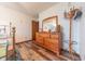 Bedroom featuring wood dresser and wall mirror. Decorative hat and coat rack at 3003 Foxpointe Dr, Columbus, IN 47203