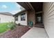 Welcoming front entry with a brick accent wall and a cozy garden bed at 3003 Foxpointe Dr, Columbus, IN 47203
