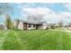 Charming home with a well-maintained lawn, attached garage, brick accents and beautiful landscaping at 3003 Foxpointe Dr, Columbus, IN 47203