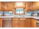 Well-lit kitchen featuring wood cabinets, a stainless steel sink, and modern appliances at 3003 Foxpointe Dr, Columbus, IN 47203