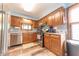 Well-lit kitchen featuring wood cabinets, a stainless steel sink, and modern appliances at 3003 Foxpointe Dr, Columbus, IN 47203