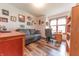 Bright home office with a cozy sofa, wooden desk by a window, and hardwood-style flooring at 3003 Foxpointe Dr, Columbus, IN 47203