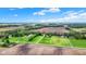 Wide aerial view highlighting the expansive property with green fields, multiple buildings, and mature trees at 3154 E German E Rd, Shelbyville, IN 46176