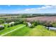 Aerial view showcasing the property's layout with multiple buildings, green fields, and surrounding landscape at 3154 E German E Rd, Shelbyville, IN 46176