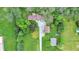 Aerial view of a property with a house, outbuildings, mature trees, and a long driveway at 3154 E German E Rd, Shelbyville, IN 46176