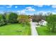 Gorgeous aerial view of the property featuring a long driveway and plenty of mature trees at 3154 E German E Rd, Shelbyville, IN 46176