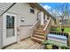 Back of house with wooden deck, stairs, and a door providing outdoor access and backyard views at 3154 E German E Rd, Shelbyville, IN 46176