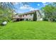 Spacious backyard featuring a deck, lush green grass, and mature trees, perfect for outdoor activities at 3154 E German E Rd, Shelbyville, IN 46176