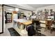 Bright basement craft room with a large workspace, sewing machines, and ample storage shelves and cabinets at 3154 E German E Rd, Shelbyville, IN 46176