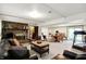 Spacious basement featuring a brick fireplace, leather sofas, and an adjacent dining area and workout space at 3154 E German E Rd, Shelbyville, IN 46176
