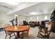 An open concept in this finished basement includes a sitting area, fireplace, and a table for dining or games at 3154 E German E Rd, Shelbyville, IN 46176