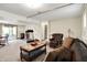 Basement living space with a sliding door to the patio, a wood-burning stove, and a leather sofa and chair at 3154 E German E Rd, Shelbyville, IN 46176