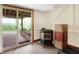 Basement space featuring a glass sliding door to the patio, a wood-burning stove, and a concrete patio at 3154 E German E Rd, Shelbyville, IN 46176