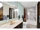 Well-lit bathroom with a marbled shower, pendant lights, and dark wood vanity, offering style and comfort at 3154 E German E Rd, Shelbyville, IN 46176