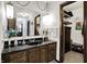 Bathroom featuring a vanity with a sink, decorative lamps, and a glimpse into a walk-in closet at 3154 E German E Rd, Shelbyville, IN 46176