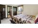 Comfortable bedroom featuring a patterned quilt, window, and closet doors, creating a warm atmosphere at 3154 E German E Rd, Shelbyville, IN 46176