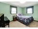 Serene bedroom with two windows, showcasing a piano and a neat bed, all complemented by soft carpeting at 3154 E German E Rd, Shelbyville, IN 46176