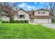 Charming two-story home featuring a well-manicured lawn, attached garage, and eye-catching red window accents at 3154 E German E Rd, Shelbyville, IN 46176