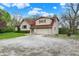 Spacious two-story home with a gravel driveway, attached garage, and inviting curb appeal with mature trees at 3154 E German E Rd, Shelbyville, IN 46176