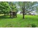 Idyllic backyard gazebo surrounded by mature trees and lush greenery creating a relaxing outdoor space at 3154 E German E Rd, Shelbyville, IN 46176