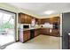 Bright kitchen with a door leading to the outdoor deck, stainless appliances, and plentiful cabinet storage at 3154 E German E Rd, Shelbyville, IN 46176