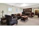 Living room features a brick fireplace, comfortable leather seating, and an inviting atmosphere at 3154 E German E Rd, Shelbyville, IN 46176