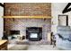 Close-up of the living room showcasing a brick fireplace with mantel, and decorative accents adding warmth at 3154 E German E Rd, Shelbyville, IN 46176
