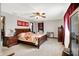 Spacious main bedroom featuring a ceiling fan and dark wood furniture, creating a relaxed and elegant setting at 3154 E German E Rd, Shelbyville, IN 46176