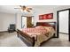 Bright main bedroom includes a wooden bed and a rocking chair, enhanced by carpeted floors and natural light at 3154 E German E Rd, Shelbyville, IN 46176