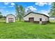 Property with a well-kept storage shed and a large outbuilding, set on a sprawling green lawn at 3154 E German E Rd, Shelbyville, IN 46176