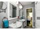 Modern bathroom featuring double sinks, tile floors, and a view of the ensuite bedroom at 319 S Randolph St, Indianapolis, IN 46201