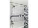 Modern bathroom with sleek gray and white tiling, and updated shower fixtures at 319 S Randolph St, Indianapolis, IN 46201