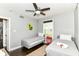 Well-lit bedroom featuring two twin beds, ceiling fan, and hardwood floors at 319 S Randolph St, Indianapolis, IN 46201