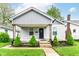 Cute covered front porch with updated columns and landscaping for added curb appeal at 319 S Randolph St, Indianapolis, IN 46201