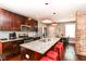 Modern kitchen with granite counters, stainless appliances, and eat-in bar with stylish lighting at 319 S Randolph St, Indianapolis, IN 46201