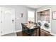 Bright dining area featuring a table with seating for four and a stacked washer/dryer at 319 S Randolph St, Indianapolis, IN 46201