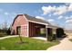Red barn featuring an open-air picnic shelter and manicured lawn at 3286 W Longbranch Dr, Monrovia, IN 46157