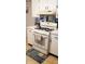 Bright kitchen featuring a gas range, white cabinets, and neutral countertops at 3348 W 800 N, Fairland, IN 46126