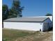 Exterior view of a white shed with a long, rectangular design and a gray metal roof at 3348 W 800 N, Fairland, IN 46126