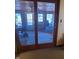 View through glass doors into a sunroom featuring wood walls, ceiling, and flooring at 3348 W 800 N, Fairland, IN 46126